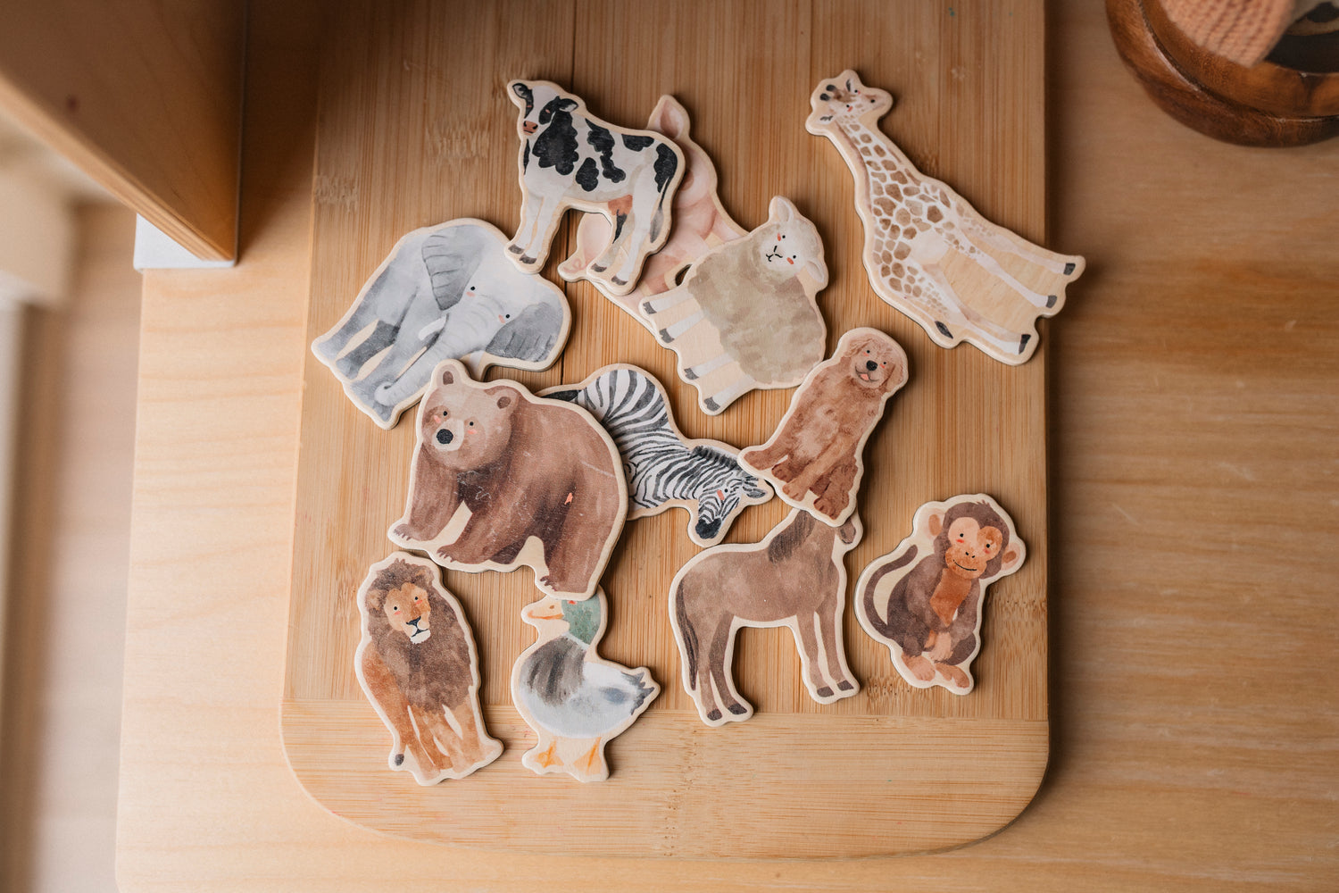Set of wooden animal magnets on a wooden board